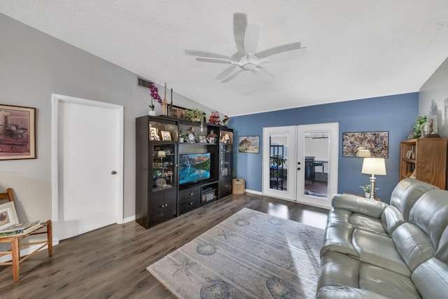 living area featuring wood finished floors, visible vents, lofted ceiling, ceiling fan, and french doors