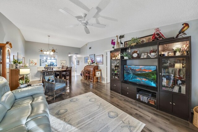 living room with ceiling fan, dark hardwood / wood-style floors, a textured ceiling, vaulted ceiling, and french doors