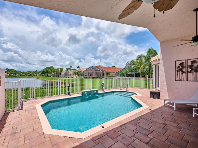 view of swimming pool with a water view, ceiling fan, and a patio area