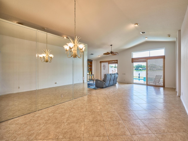 interior space with lofted ceiling, light tile patterned floors, and ceiling fan with notable chandelier