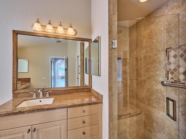 bathroom featuring vanity, toilet, and a shower with shower door