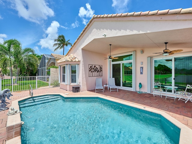 view of pool with a lanai, ceiling fan, and a patio area