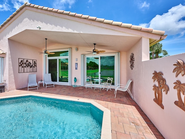 view of swimming pool with a patio area and ceiling fan