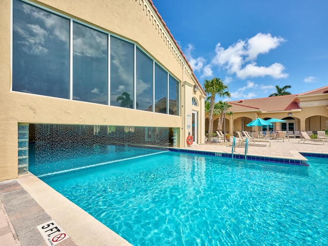 view of swimming pool featuring a patio area