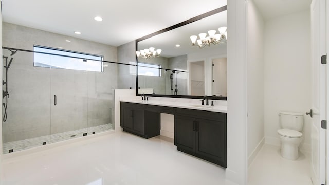 bathroom featuring vanity, toilet, and a shower with door