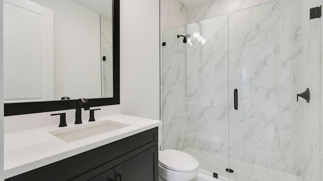 bathroom with walk in shower, vanity, and toilet