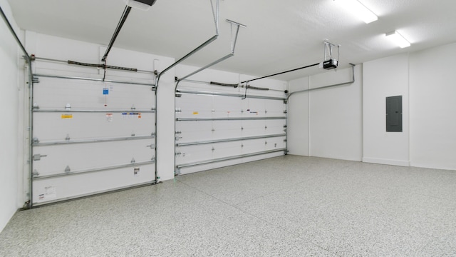 garage with a garage door opener and electric panel