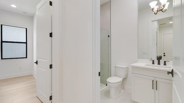 bathroom featuring hardwood / wood-style flooring, an enclosed shower, vanity, toilet, and a chandelier