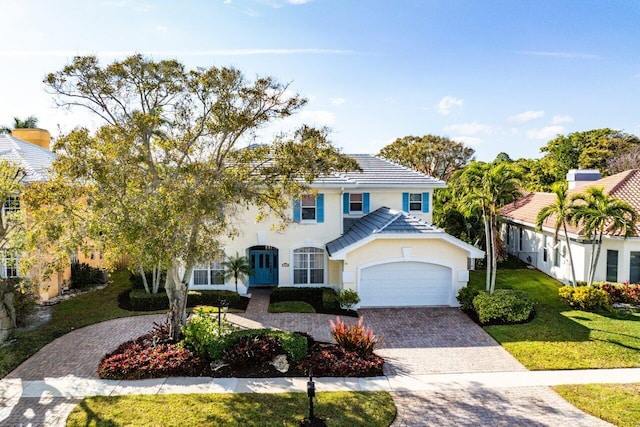 view of front of property with a garage and a front yard