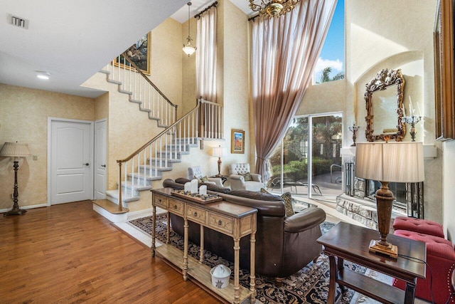 living room featuring hardwood / wood-style flooring and a high ceiling