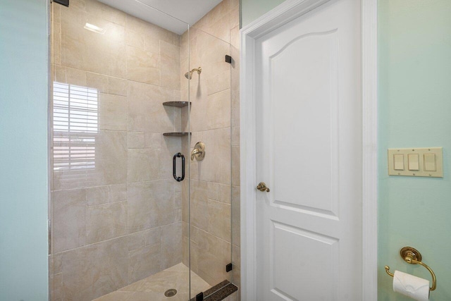 bathroom featuring a shower with door