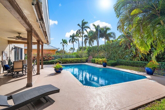 view of swimming pool with ceiling fan and a patio