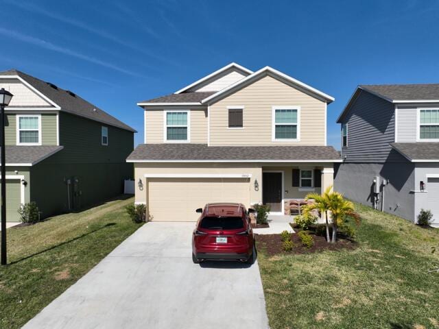 view of front of home with a garage and a front lawn