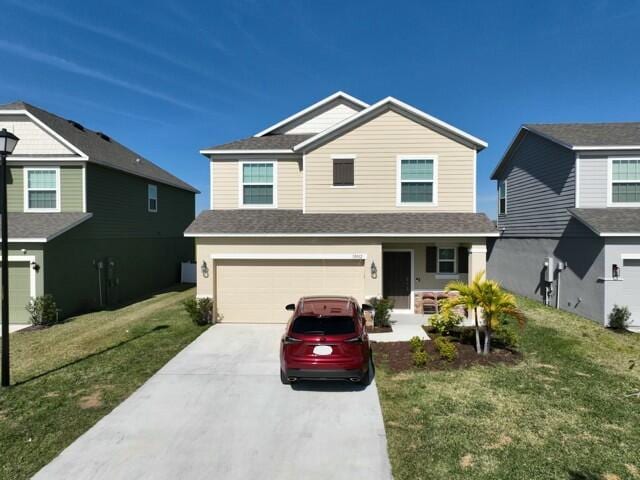 view of front facade featuring a garage and a front lawn