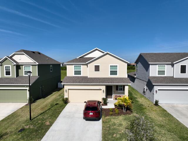 view of front of house featuring a garage and a front lawn