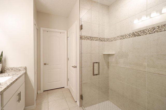 bathroom with vanity, tile patterned floors, and walk in shower