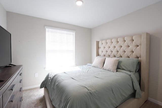 bedroom featuring light carpet