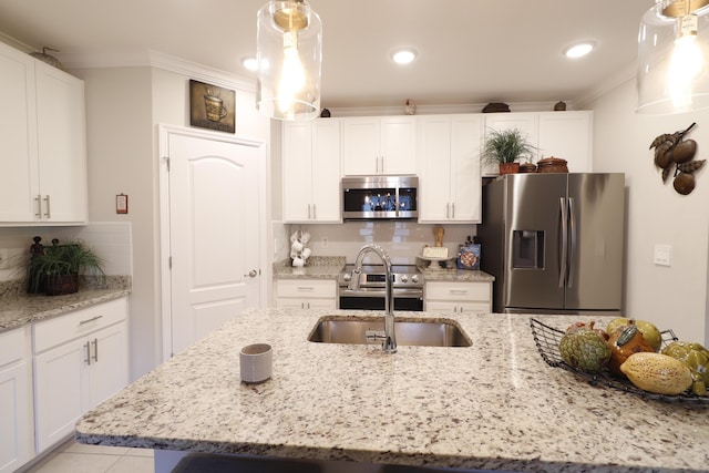 kitchen featuring white cabinetry, stainless steel appliances, crown molding, and decorative light fixtures