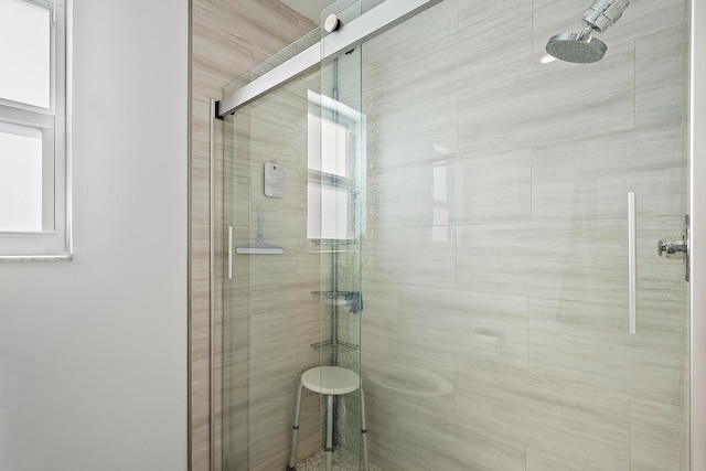 bathroom featuring a shower with door