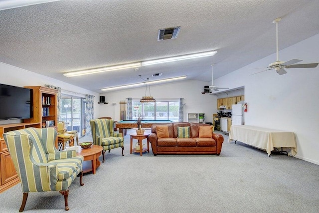 carpeted living room featuring a textured ceiling, vaulted ceiling, and ceiling fan