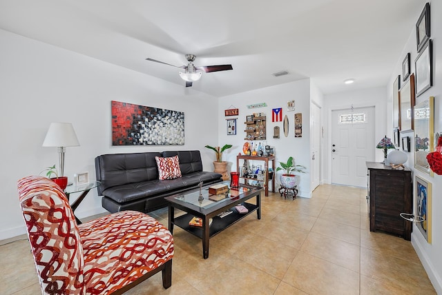 tiled living room featuring ceiling fan