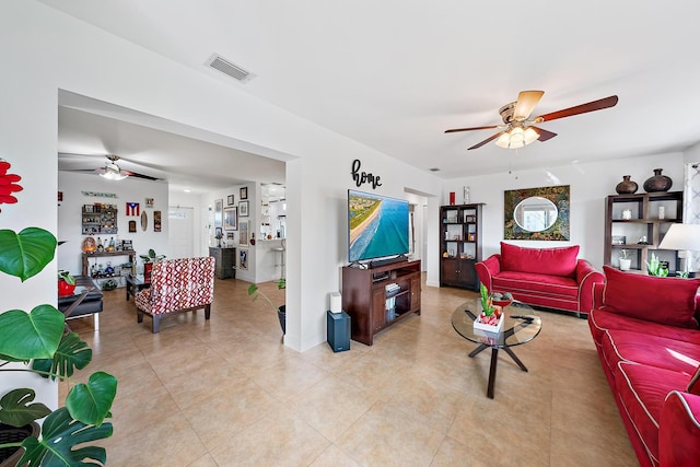 living room featuring light tile patterned floors and ceiling fan