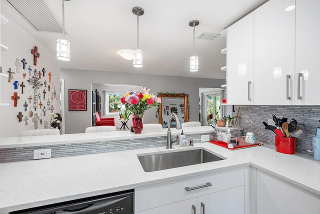 kitchen with white cabinetry, sink, pendant lighting, and black dishwasher