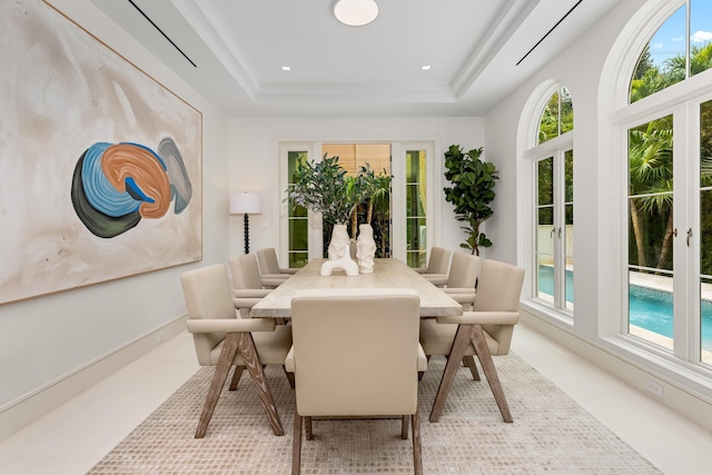 dining area with a raised ceiling