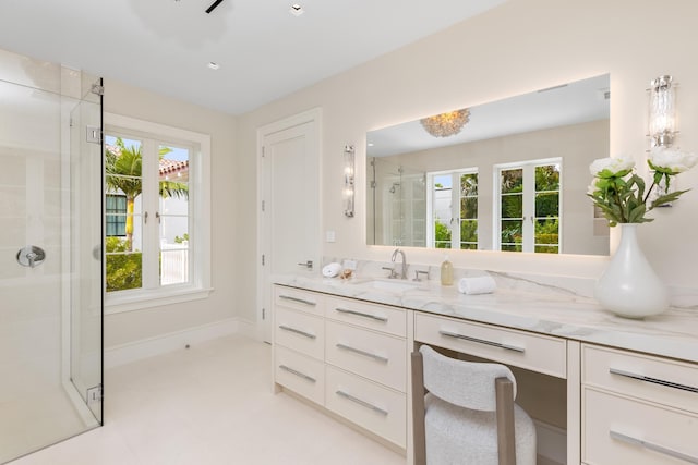 bathroom with vanity and a shower with door