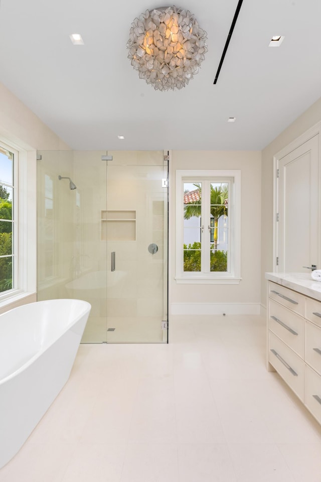 bathroom with vanity and shower with separate bathtub