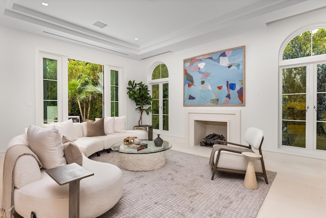 living room with a tray ceiling and french doors