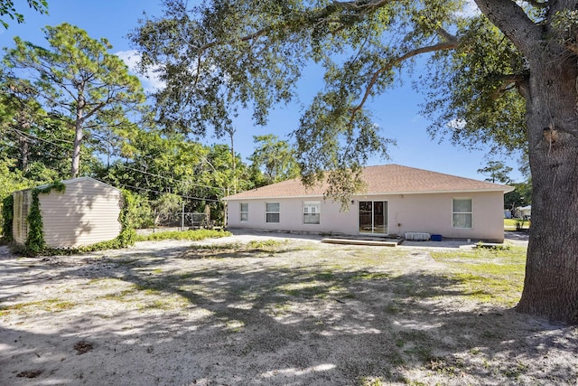 back of property with a storage unit