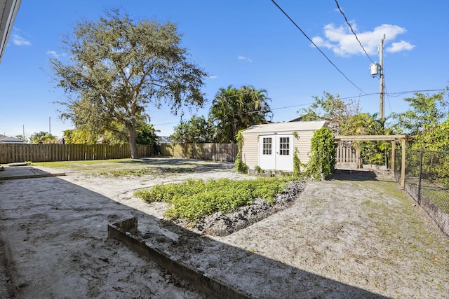 view of yard featuring a patio area and a storage unit