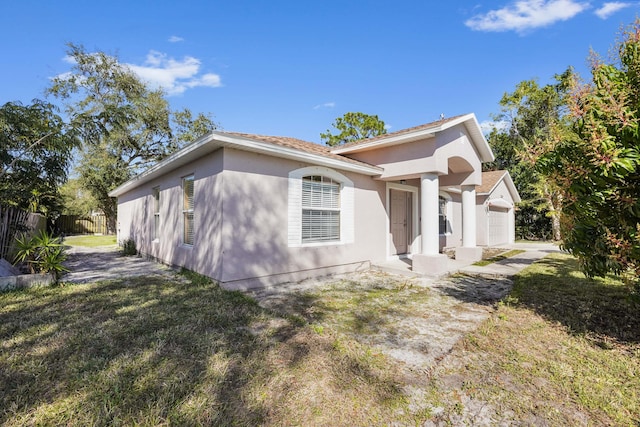 view of front of home featuring a garage and a front lawn