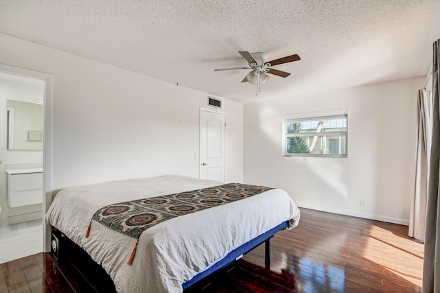 42 Burgundy Unit A, Delray Beach, FL 33484 - bedroom with ceiling fan, ensuite bathroom, dark hardwood / wood-style flooring, and a textured ceiling