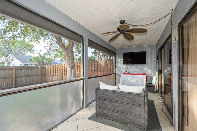 unfurnished sunroom with ceiling fan