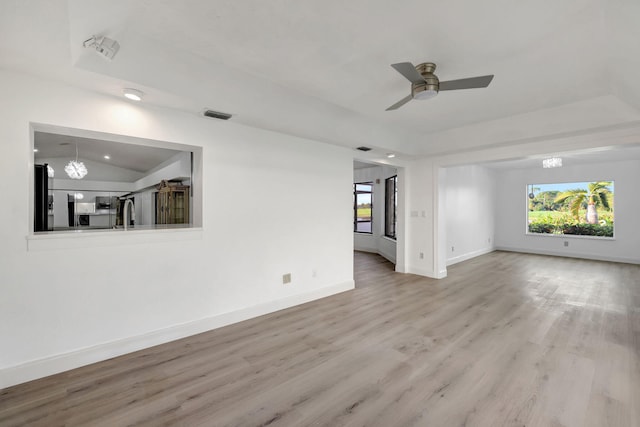 unfurnished living room with ceiling fan, lofted ceiling, and hardwood / wood-style floors