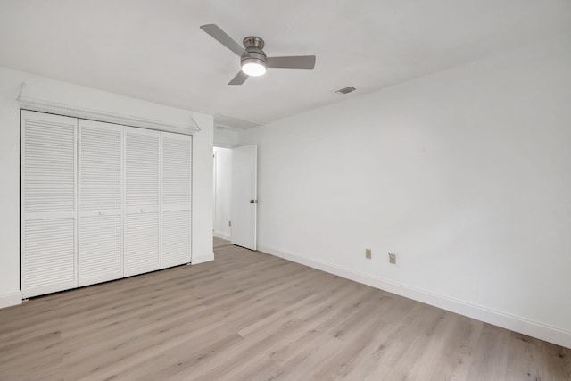 unfurnished bedroom with ceiling fan, light hardwood / wood-style floors, and a closet