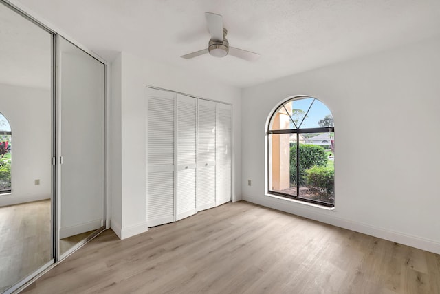 unfurnished bedroom with light wood-type flooring and ceiling fan