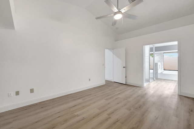 spare room with ceiling fan, lofted ceiling, and light wood-type flooring