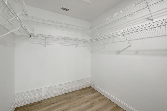 walk in closet featuring hardwood / wood-style floors