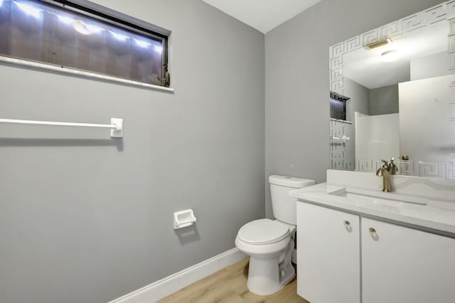 bathroom featuring vanity, toilet, and wood-type flooring