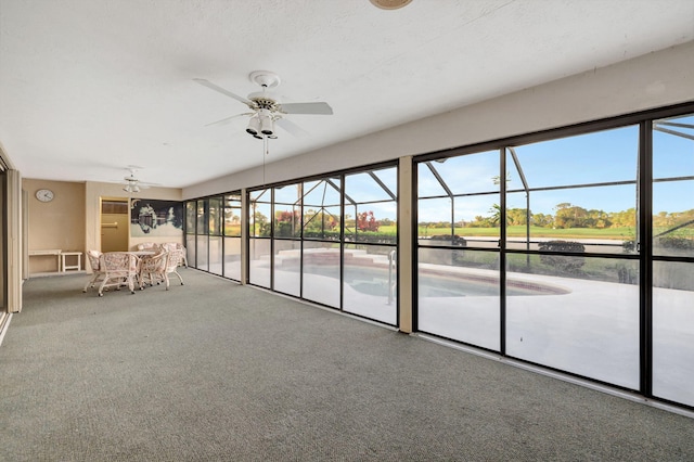 unfurnished sunroom with ceiling fan