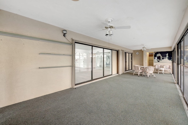 unfurnished sunroom with ceiling fan