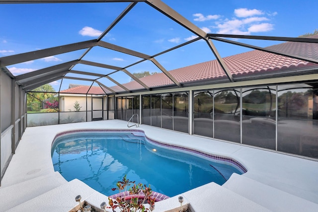 view of pool with a patio area and glass enclosure