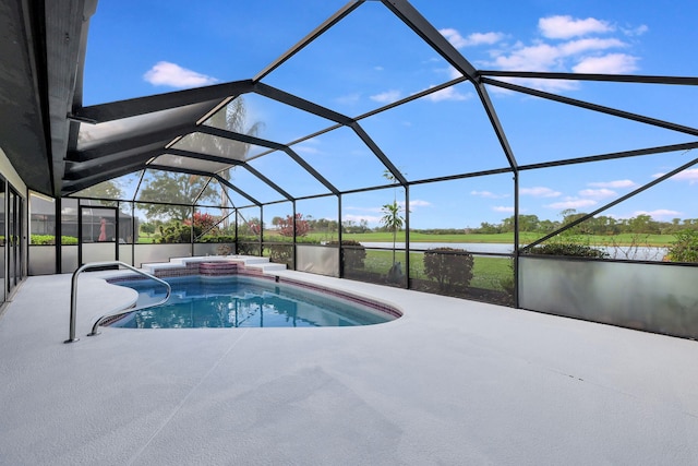 view of swimming pool with a water view, a patio area, and glass enclosure