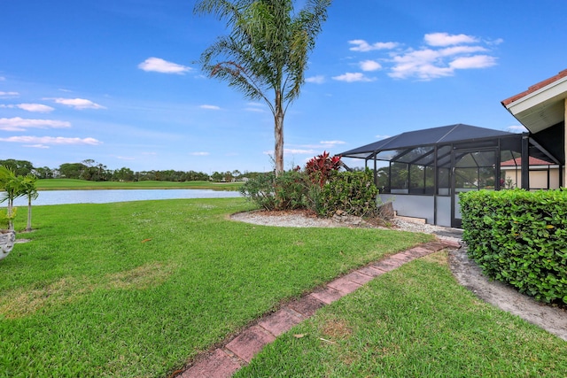 view of yard with a water view and a lanai