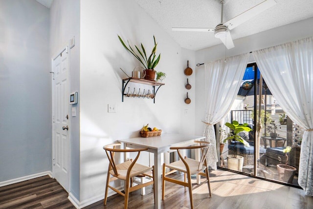 interior space featuring dark hardwood / wood-style flooring, ceiling fan, a textured ceiling, and breakfast area