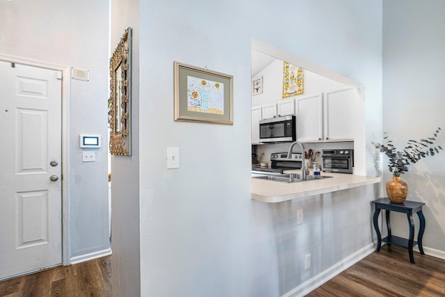 hallway featuring sink and dark hardwood / wood-style floors