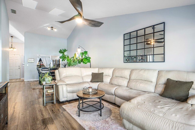 living room with ceiling fan, lofted ceiling, and dark hardwood / wood-style flooring